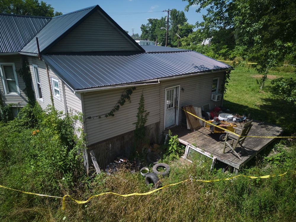 On Thursday, windows and doors at the home had been boarded up (AP)