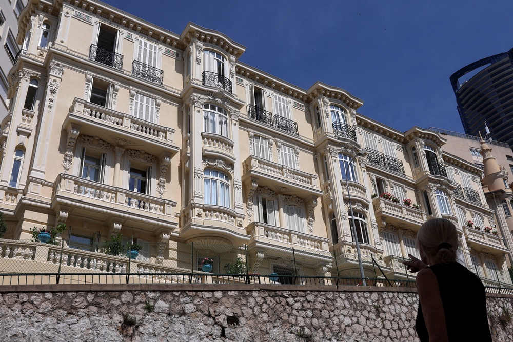A woman points at a residential building, the site of an explosion that occurred on Monday (Reuters)