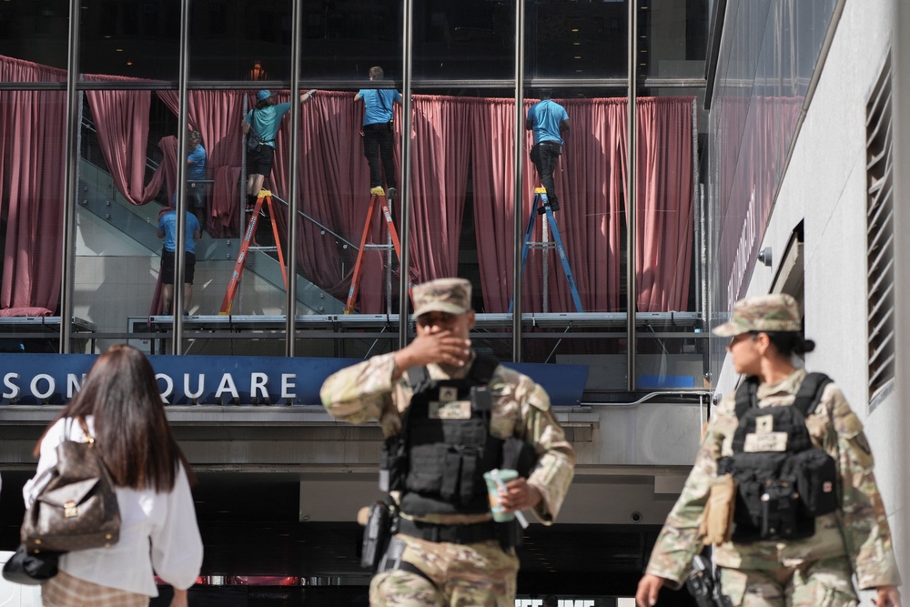 Workers operate inside Madison Square Garden, ahead of a reported wedding Taylor Swift and Travis Kelce wedding, as members of the Armed Forces stand outside in New York City (Reuters)