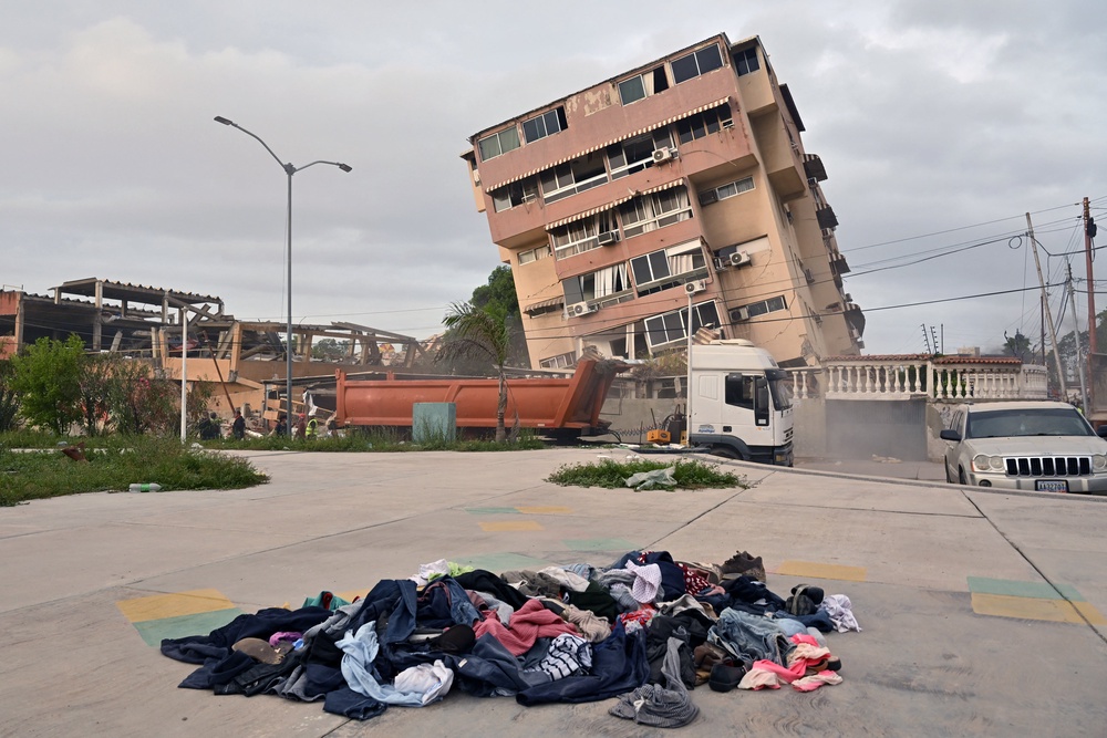 A pile of clothes lies on the ground in front of a partially collapsed building in Caraballeda, La Guaira state, Venezuela (AFP/Getty)
