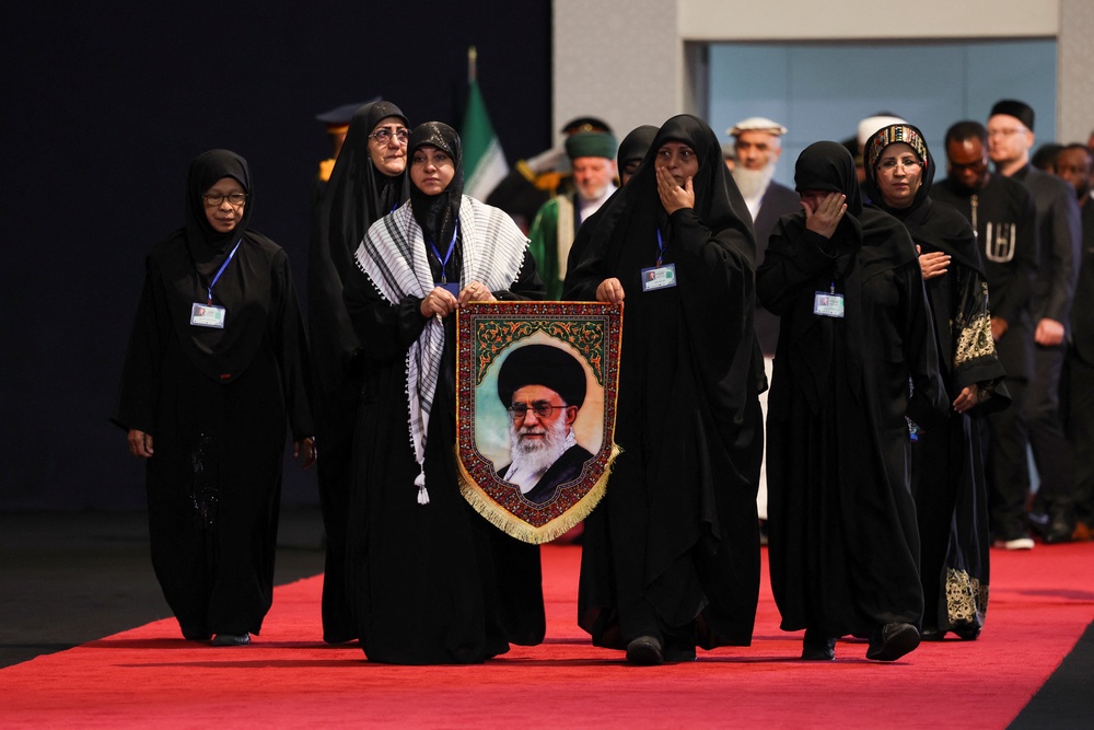 Women react as they walk to pay their respects near the coffins of Iran's late Supreme Leader Ayatollah Ali Khamenei and his family members (Reuters)