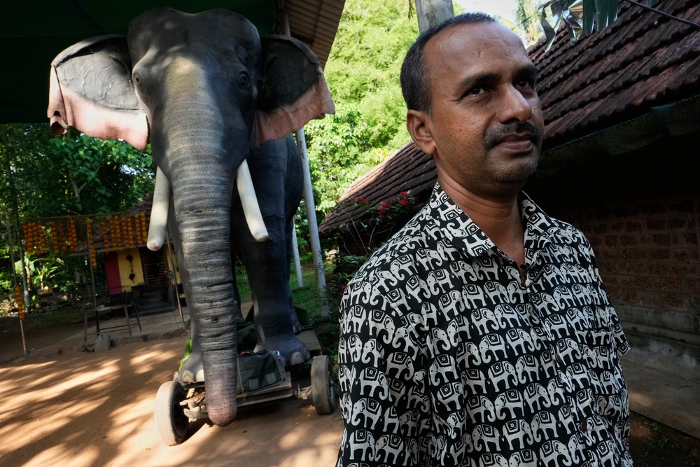 Rajkumar Namboothiri, the temple's head priest, stands next to the robotic elephant Irinjadapilly Raman at the Irinjadapilly Sree Krishna Temple in Thrissur, in the southern Indian state of Kerala, Friday, May 22, 2026. (AP Photo/Aijaz Rahi) (Copyright 2026 The Associated Press. All rights reserved)