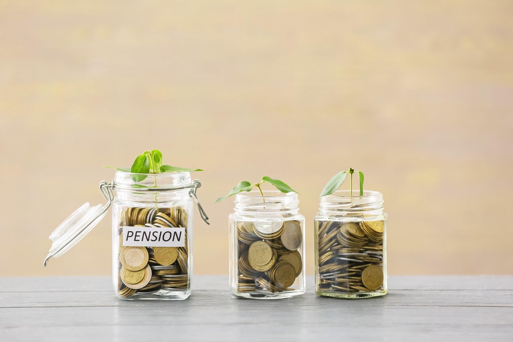 Three glass jars of coins labelled pensions (Alamy/PA)