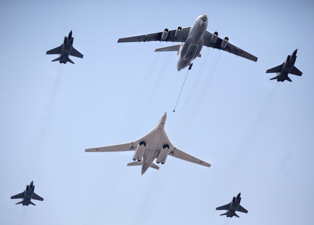 A Russian Tu-160 strategic bomber escorted by fighter jets performs refueling during a Victory Day parade (AFP/Getty)