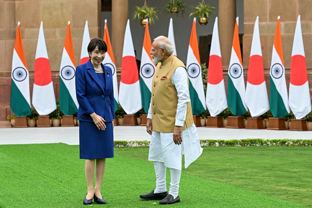 India's Prime Minister Narendra Modi (R) looks on as Japan's Prime Minister Sanae Takaichi reacts before their meeting at the Hyderabad House (AFP/Getty)