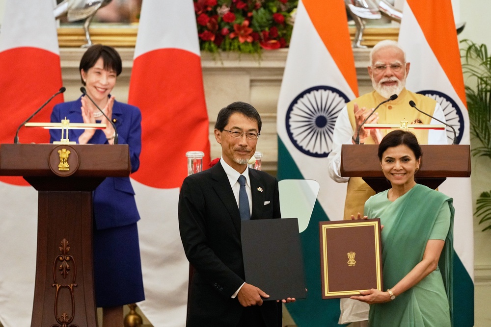 Japan's Prime Minister Sanae Takaichi, left, and India's Prime Minister Narendra Modi, right, applaud as Japan's ambassador to India Ono Keiichi, center left, and India's ambassador to Japan Nagma Mohamed Mallick hold copies of a signed bilateral agreement after their delegation level meeting in New Delhi, India (AP)