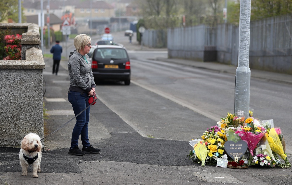 A woman stops to pay her respects at the scene on Fanad Drive, Derry, where 29-year-old journalist Lyra McKee was shot (PA)