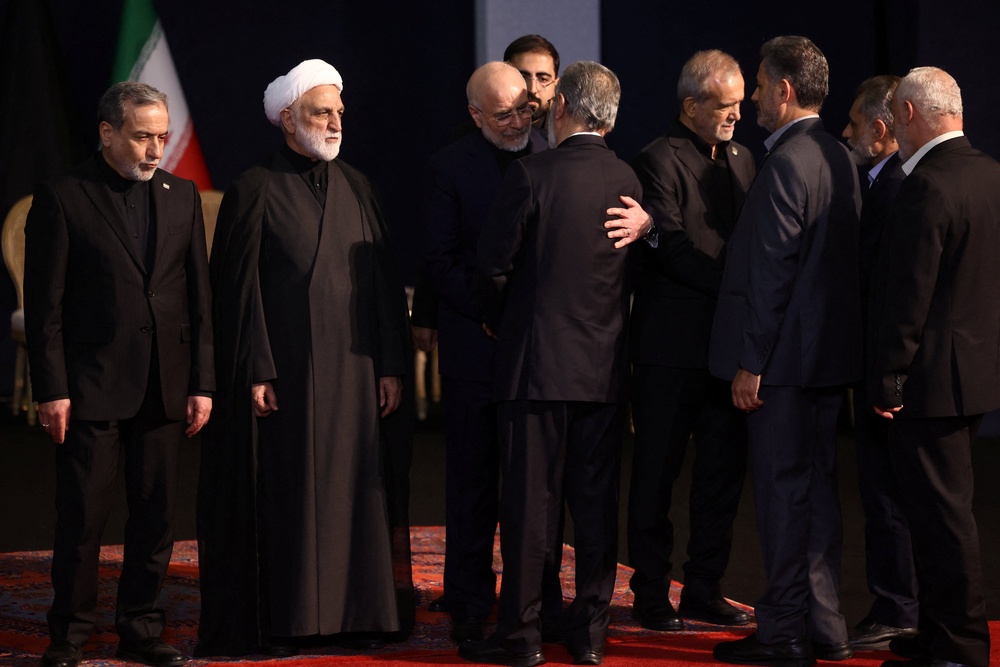 Iranian Parliament Speaker Mohammad Baqer Qalibaf embraces Ziyad al-Nakhalah, Secretary-General of Palestinian Islamic Jihad as they attend a farewell ceremony for Iran's late Supreme Leader Ayatollah Ali Khamenei (Reuters)