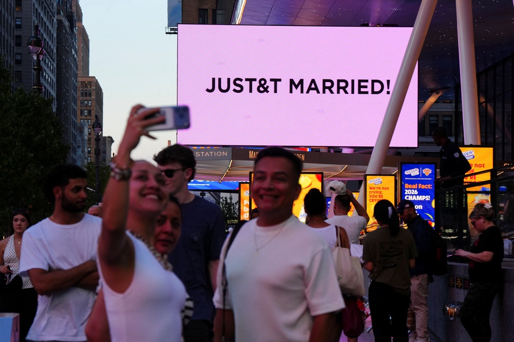 Fans celebrated outside the ‘Just married’ sign (Reuters)