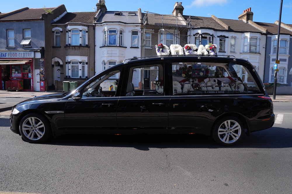 The hearse makes its way through East Ham (Yui Mok/PA) (PA Wire)