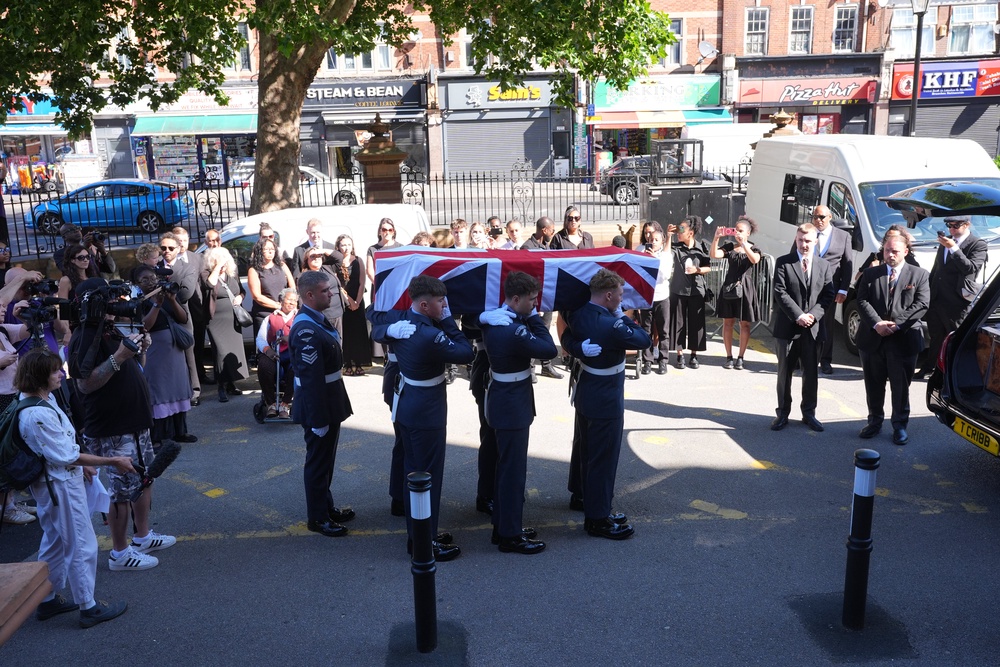 Members of the RAF take the coffin into East Ham town hall (Yui Mok/PA) (PA Wire)