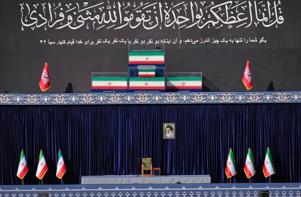 The coffins of the late Iranian Supreme Leader Ayatollah Ali Khamenei and members of his family are displayed on a platform above an empty chair at the start of the dayslong funeral ceremonies at the Imam Khomeini Mosalla Grand Mosque in Tehran, Iran, Saturday, July 4, 2026. (AP Photo/Altaf Qadri) (AP Photo/Altaf Qadri)