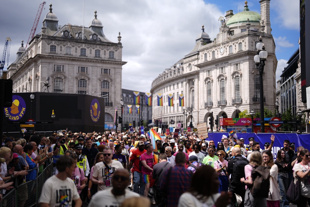 People pass through Piccadilly Circus as they take part in the Pride in London parade in central London (Jordan Pettitt/PA) (PA Wire)