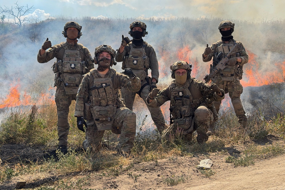 French volunteer members from the Revanche Tactical Group, which operates under the International Legion of the Defence Intelligence of Ukraine, pose for a photograph as they take part in a military training on a burning field at an undisclosed location, in the Zaporizhzhia region, on July 3, 2026, amid the Russian invasion of Ukraine. (AFP/Getty)