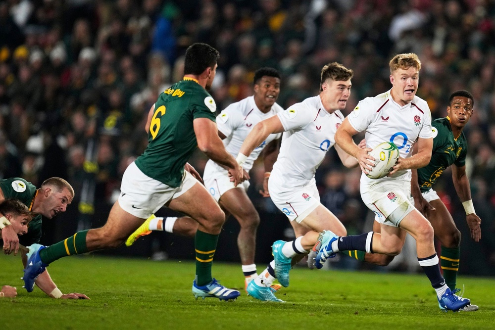 England's Fin Smith, right, runs with the ball during the Nations Championship Test (AP Photo/Themba Hadebe)