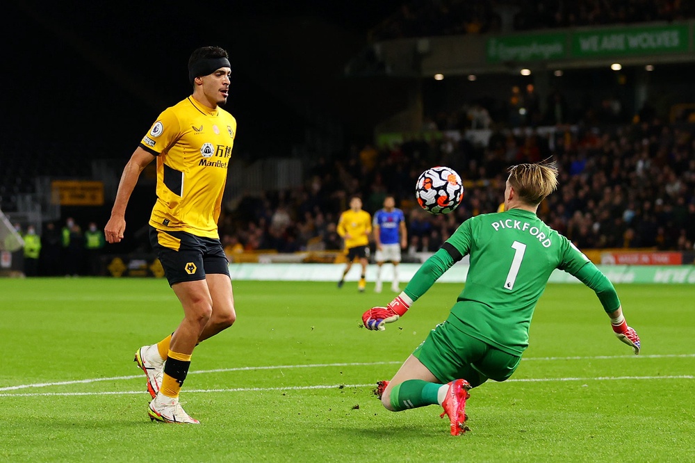 Raul Jimenez of Wolverhampton Wanderers scores their team's second goal past Jordan Pickford of Everton in 2021 (Getty)