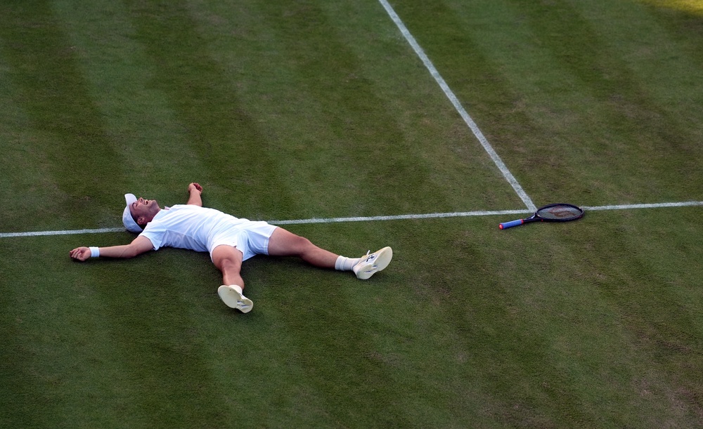Arthur Fery fell to his back after beating Zizou Bergs to reach the fourth round of Wimbledon (PA)