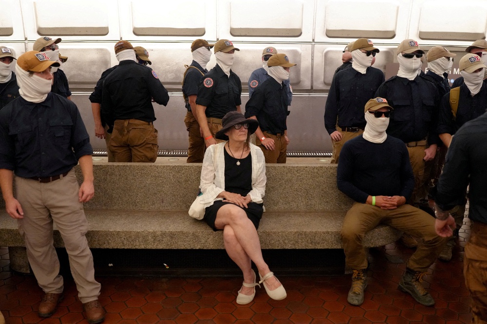 Members of the group surround a commuter at Eastern Market metro station (Reuters)