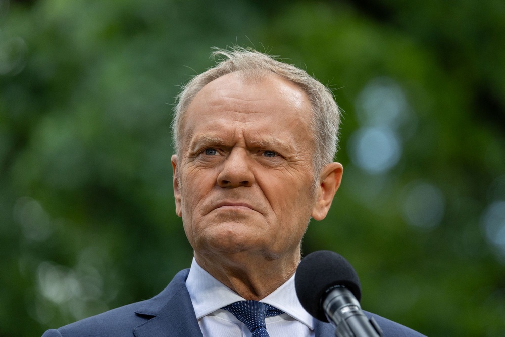Poland's Prime Minister Donald Tusk speaks to the press during a press conference in the gardens of the Prime Minister's Chancellery building in Warsaw (AFP via Getty Images)