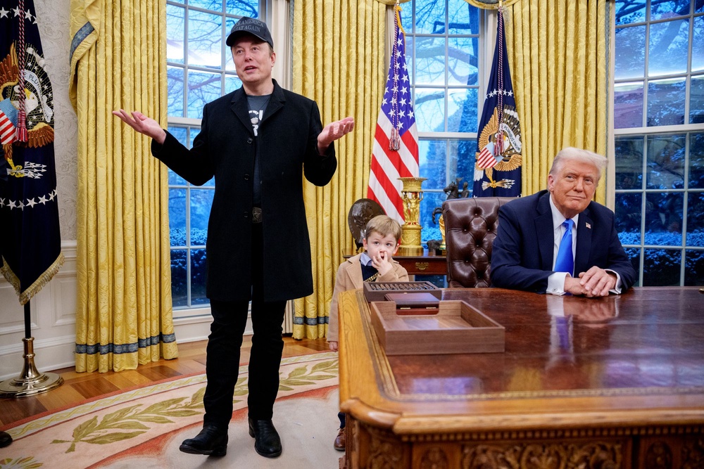 Musk, accompanied by Trump and Musk’s son X, speaks during an executive order signing in the Oval Office in 2025 (Getty)