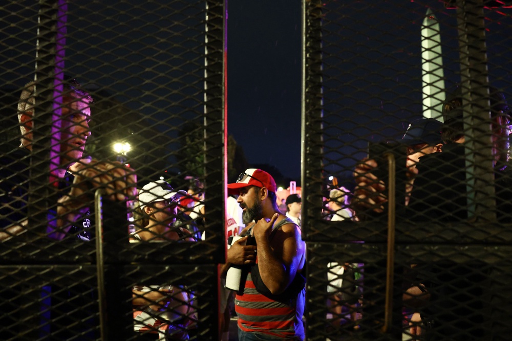 When Trump announced shortly after 9 p.m. that the speech was going ahead and the site would reopen at 9:45 p.m., pictures showed huge crowds lining up at the security gates to get back into the event (Getty)