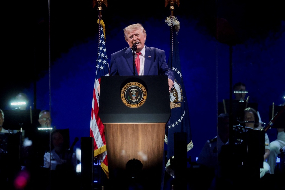 Trump took some partisan shots, hitting out against communism and demanding a voter ID law as he spoke about America’s might (Reuters)
