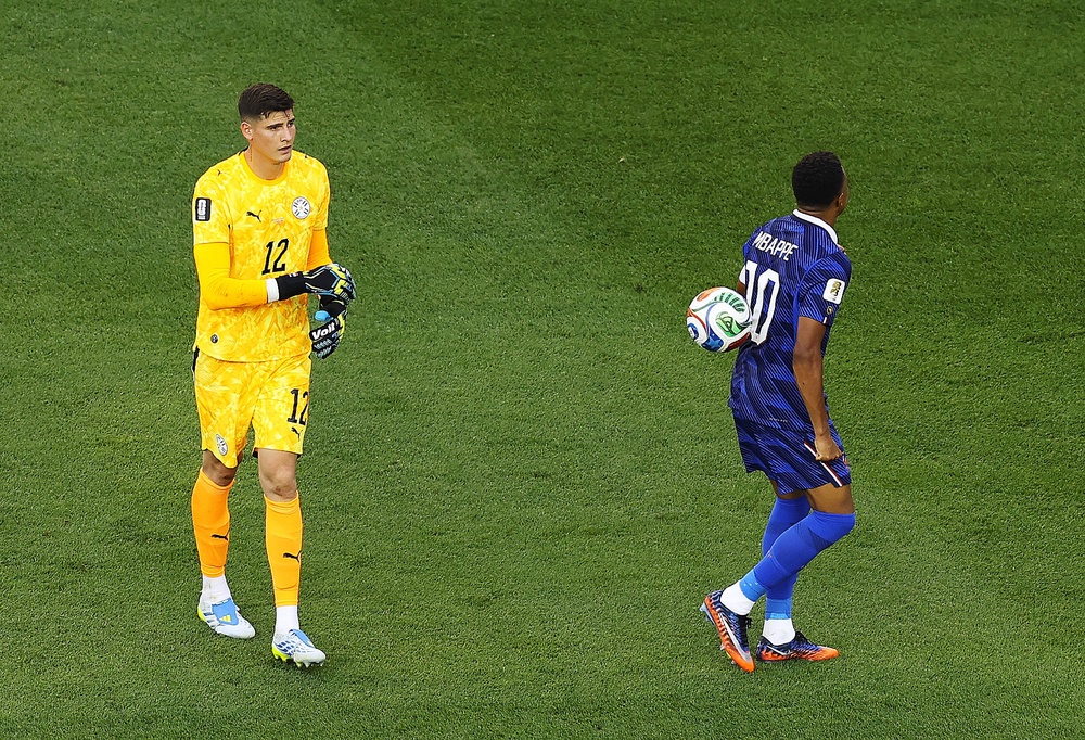 Paraguay keeper Orlando Gill threw the ball at Kylian Mbappe's back after the striker refused to shake hands with him (Getty)