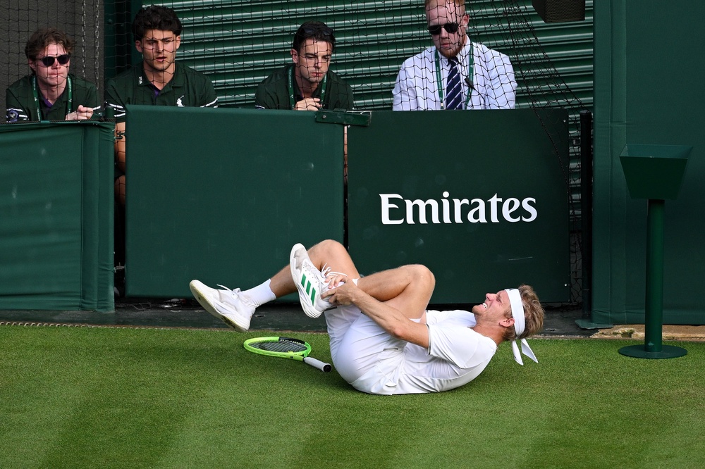 Davidovich Fokina was left clutching his ankle after sliding for the ball on the grass (Getty)