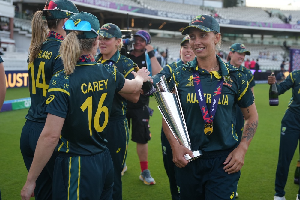 Australia's Ashleigh Gardner, carries the trophy as teammates celebrate (AP)