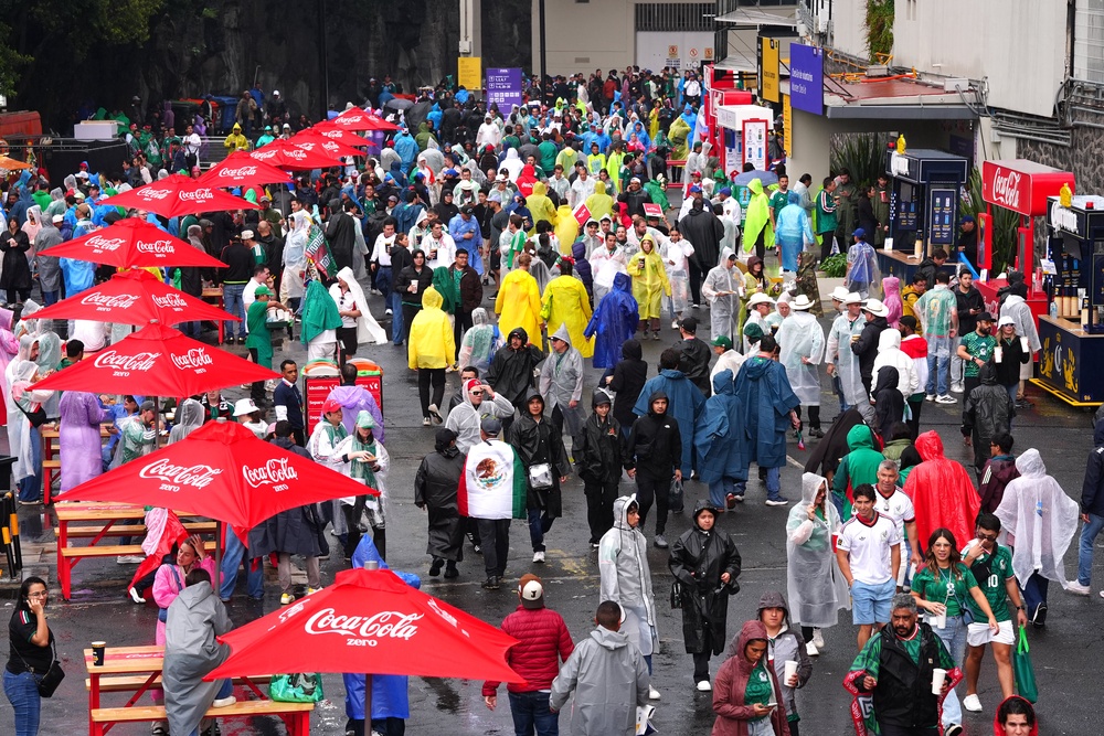 A general view of fans as it rains outside the stadium ahead of the FIFA World Cup Round of 16 match at Mexico City Stadium (PA)