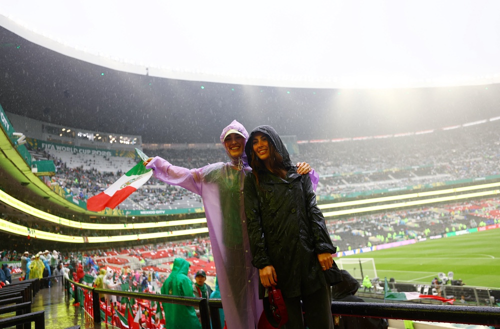 Mexico fans wear rain ponchos inside the stadium before the match after kick off has been delayed due to the weather REUTERS/Daniel Becerril (Reuters)