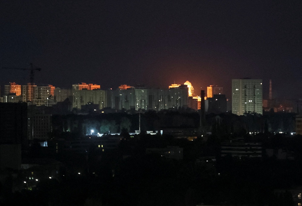 An explosion lights up the sky over the city during a Russian missile and drone strike in Kyiv (Reuters)