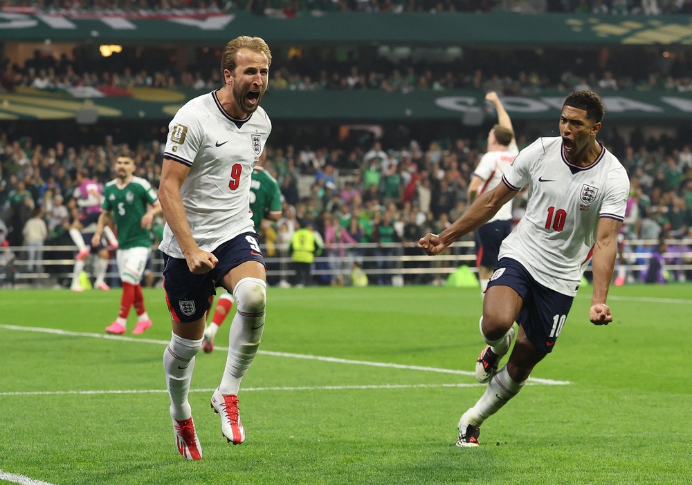 Harry Kane of England celebrates with Jude Bellingham after converting a penalty (Getty)