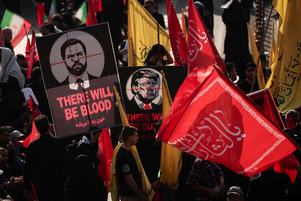 Mourners hold anti U.S. signs as people gather on the day of a funeral procession for Iran's late Supreme Leader Ayatollah Ali Khamenei (Reuters)