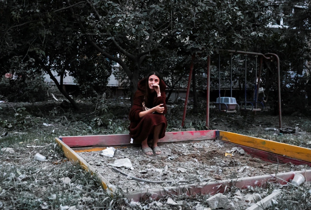 A resident, Alona, reacts as she fears her friend is under the rubble of the apartment building that was struck during Russian missile and drone strikes in Kyiv (Reuters)