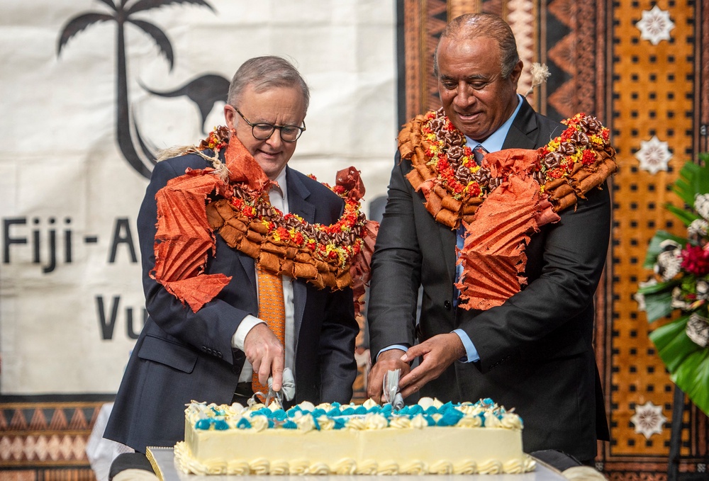 Anthony Albanese and Fiji’s public works minister Ro Filipe Tuisawau cut a cake during the opening of the Vuvale Skills hub in Suva (AFP/Getty)