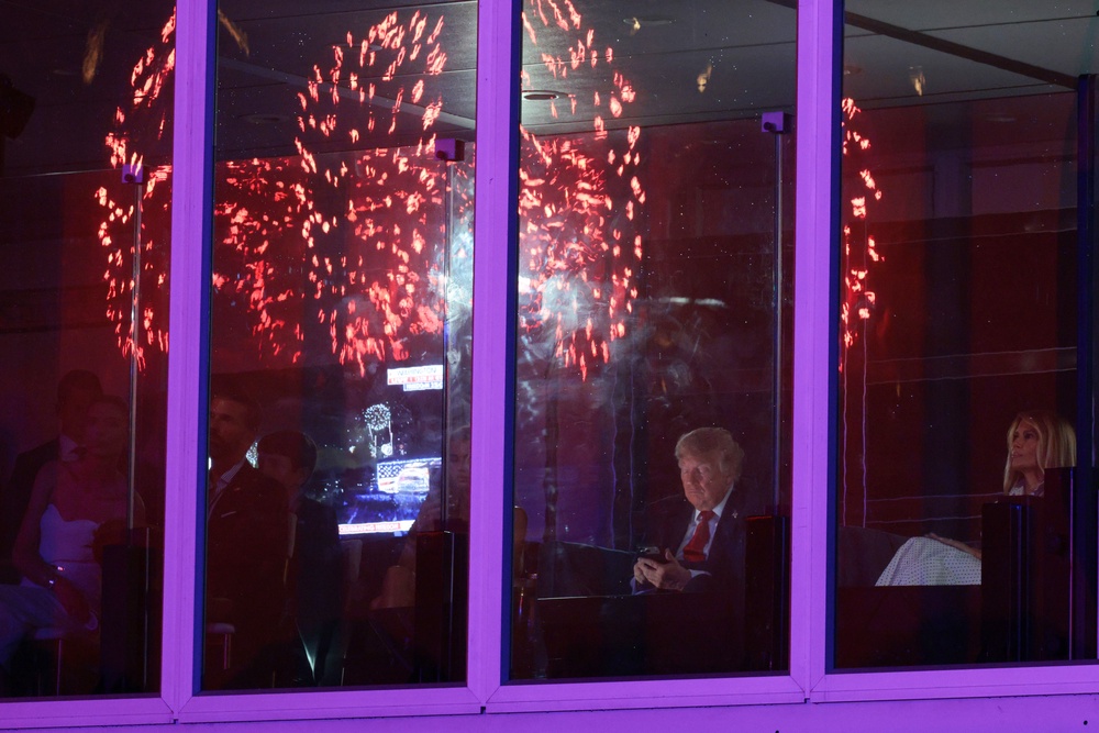 The president and First Lady Melania Trump watched the fireworks on the Mall, which kicked off shortly before midnight, from a sealed off viewing area (Getty Images)