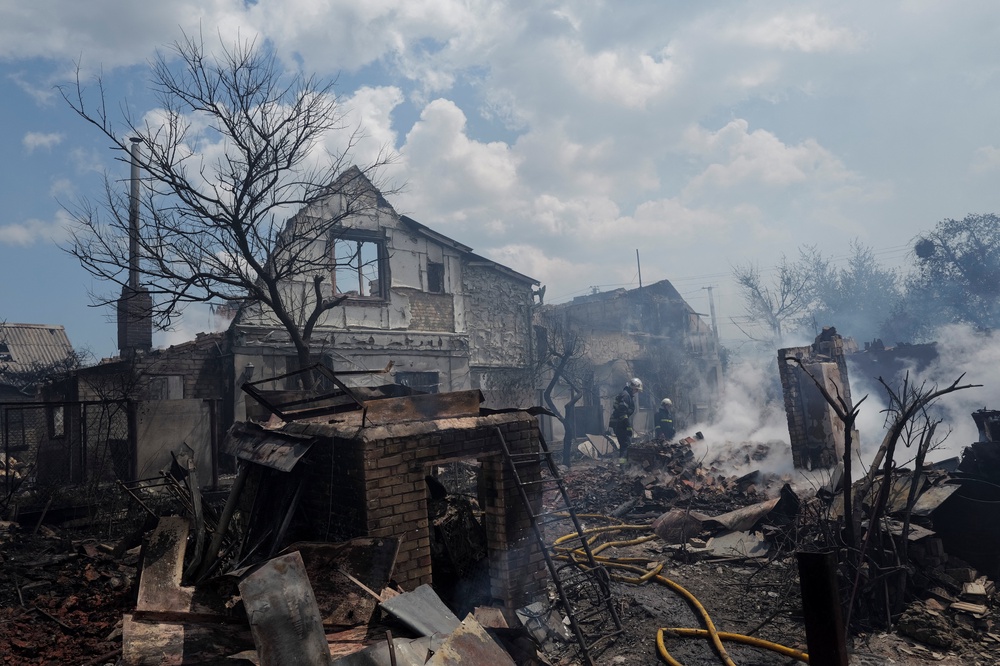 Firefighters work at a site of strikes near Kyiv (Reuters)