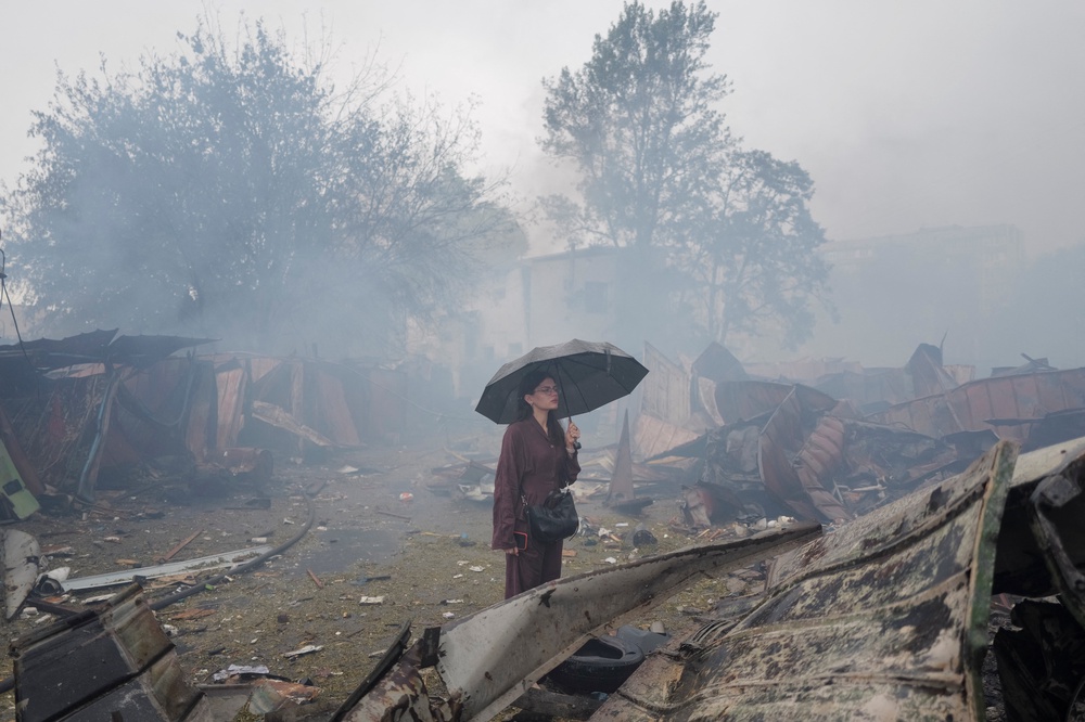 A resident stands at a site of a Russian missile and drone strikes on the outskirts of Kyiv on Monday (Reuters)