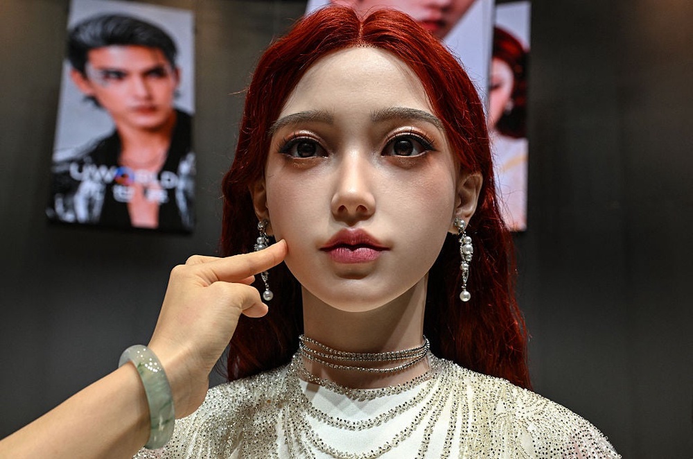 A woman touches the face of a humanoid robot during the launch of UBTech's U1 humanoid robot in Shenzhen, China's Guangdong province on 30 June, 2026 (AFP via Getty Images)