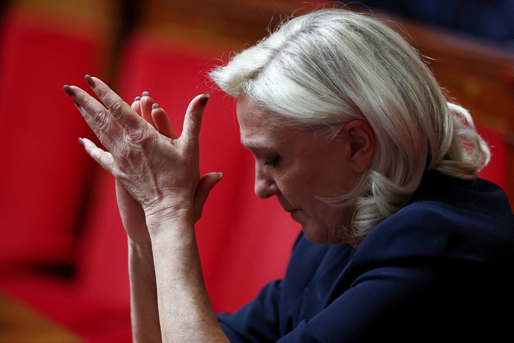 Le Pen applauds during questions to the government sessions at the National Assembly in Paris in June (Reuters)