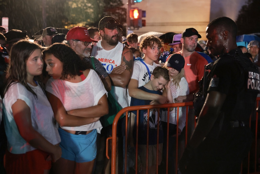 Many attendees clustered near barricades in the rain as officers encouraged people to disperse and take shelter (Getty Images)