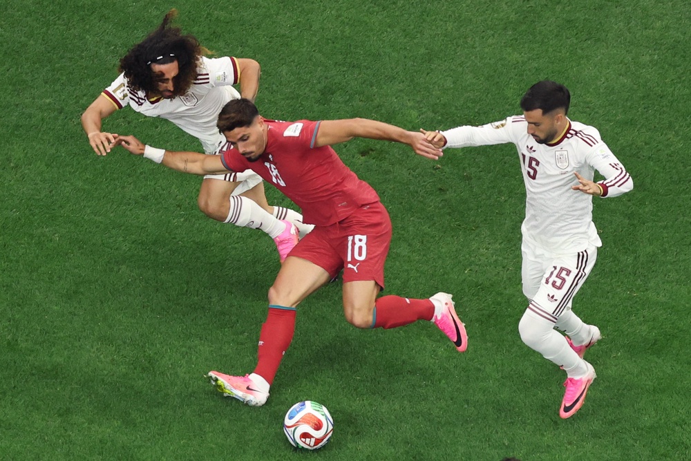 Portugal's Pedro Neto, center, tries to get past Spain's Marc Cucurella, left, and Álex Baena (AP)