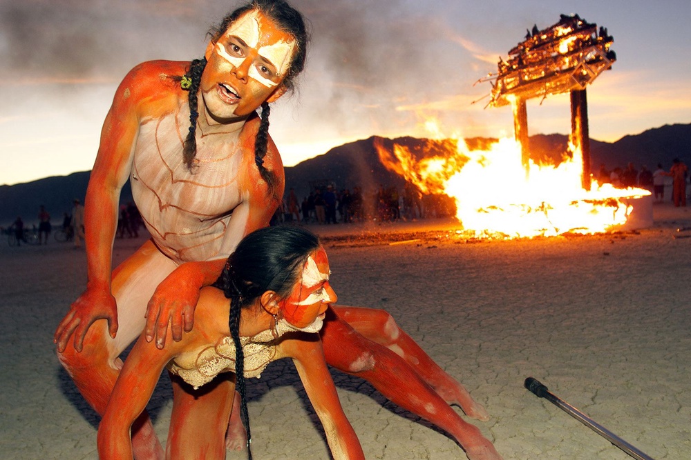 The artist Thomas Wood and a companion performing in front of a fire at Burning Man in 1999 (Hector Mata/AFP/Getty)