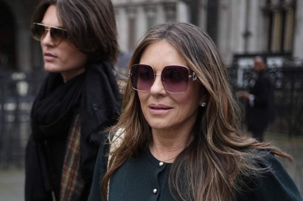 Elizabeth Hurley leaving the Royal Courts of Justice with her son Damian during the trial (PA Wire)