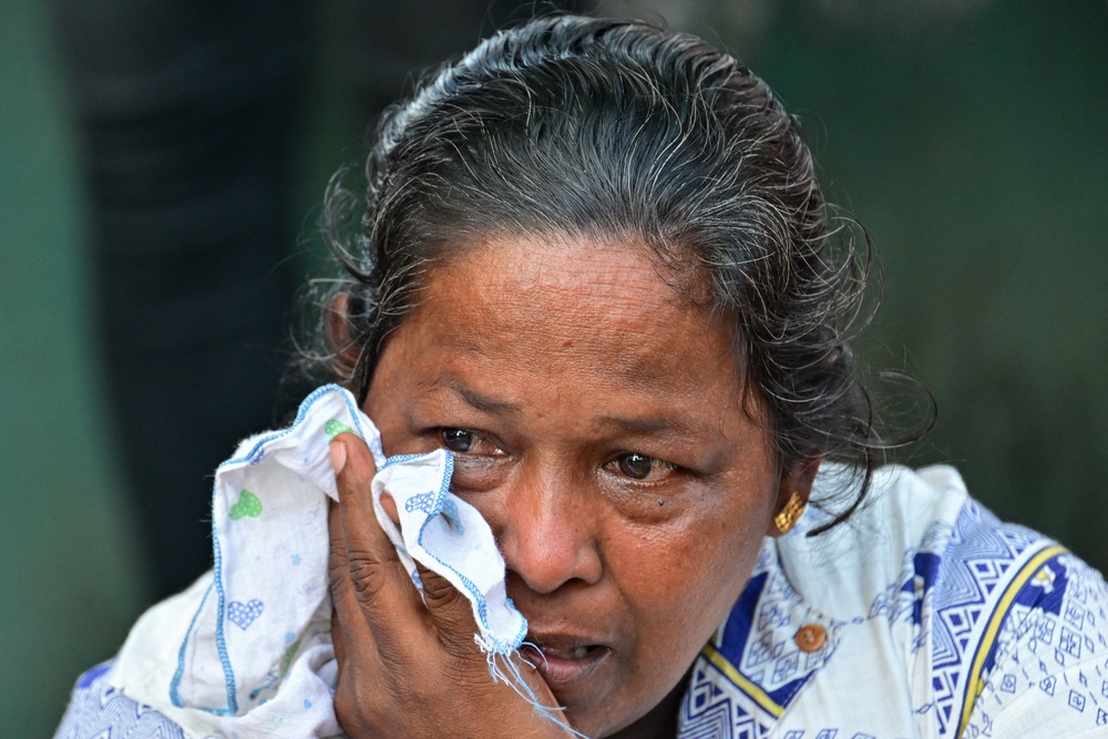 A relative of a victim killed in overnight clashes between inmates of two drug gangs, grieves in front of the Negombo prison on the outskirts of Colombo (AFP/Getty)