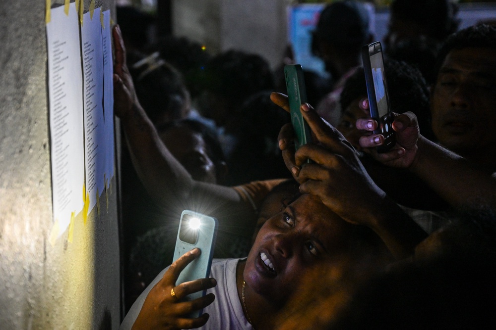 Relatives check namelists identifying victims of overnight clashes between prison inmates of two drug gangs, displayed outside a hospital in Negombo on the outskirts of Colombo (AFP/Getty)