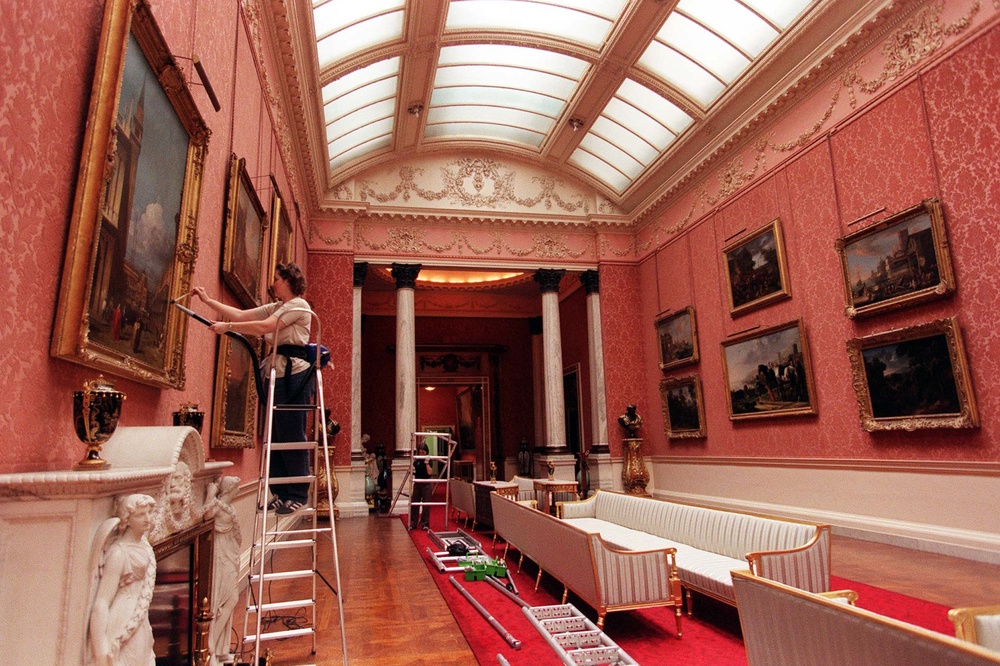 A cleaner dusts the frames in the Picture Gallery on 31 July 1998 (PA)