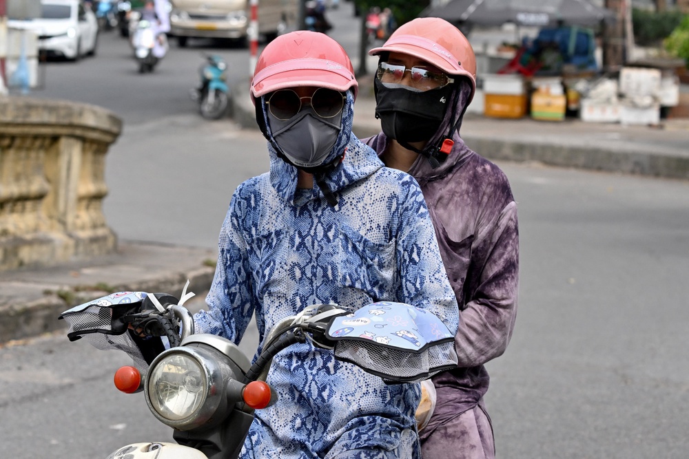 Motorcyclists cover up to avoid the heat in Hanoi (AFP/Getty)