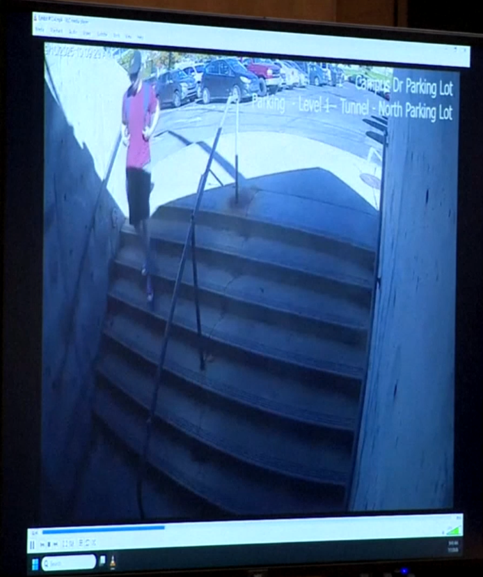 In one clip, an individual dressed in a red t-shirt and shorts can be seen walking down a campus stairwell (Reuters)